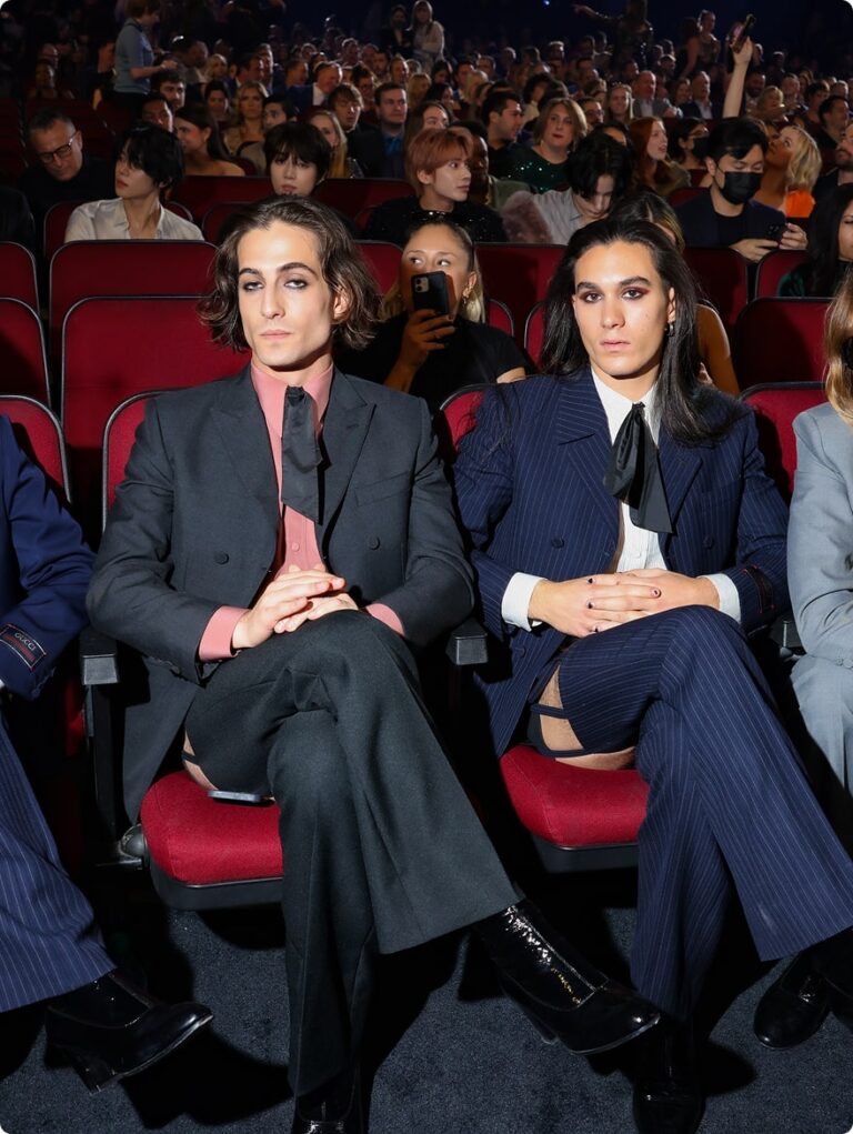 Two men in suits sat looking at the camera