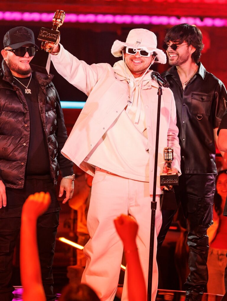 Man accepting award and holding his trophy up