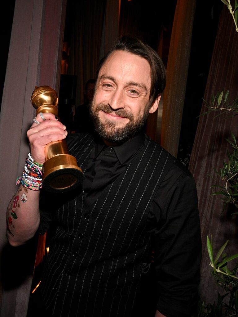 Man holding his Golden Globe