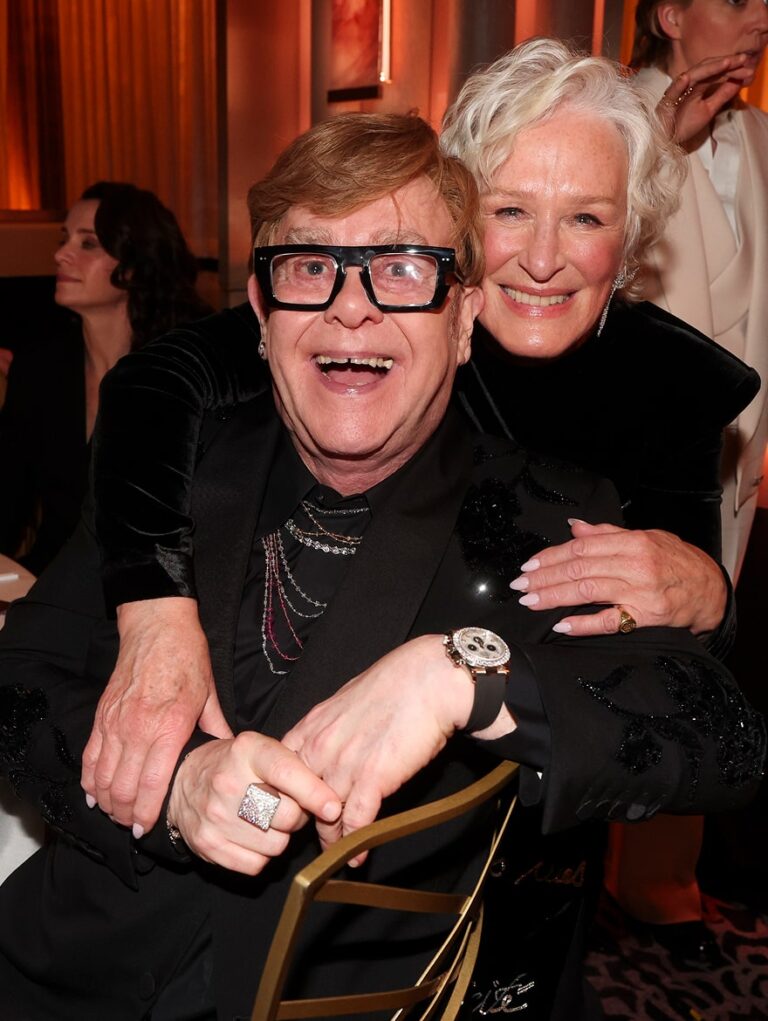 Elton John and woman laughing and posing