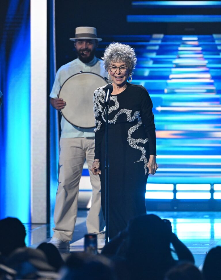 Woman presenting award on stage