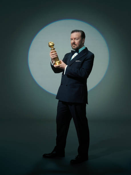 Ricky Gervais holding Golden Globe trophy